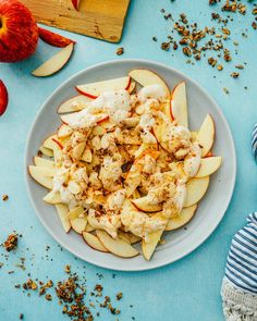 an apple salad is served on a plate with apples and cinnamons around the bowl