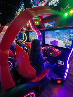 a woman playing a video game on the nintendo wii at an indoor gaming center in tokyo, japan