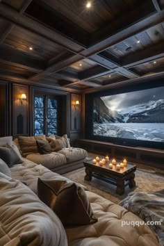 a living room filled with furniture and a flat screen tv mounted to the wall next to a fireplace