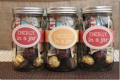 three mason jars filled with chocolates and energy in a jar labels on the lids