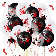 a bunch of black and white balloons with red hand prints on them that say you're next