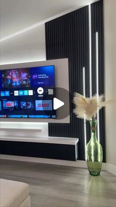 a large flat screen tv mounted to the side of a wall in a living room