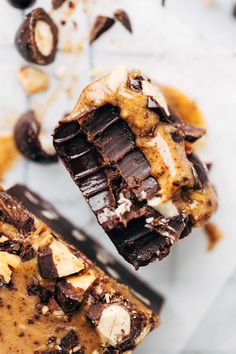 two pieces of chocolate peanut butter fudge brownie on top of each other with one bite taken out