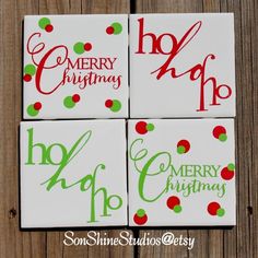 four coasters with merry christmas designs on them sitting on a wooden surface, one is green and the other is red