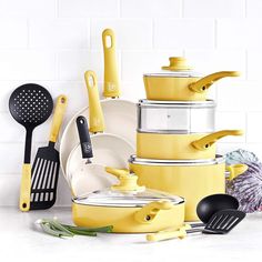 yellow pots and pans are stacked on top of each other