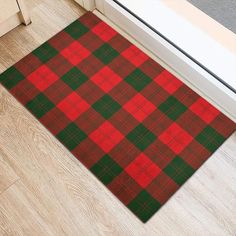 a red and green plaid door mat on the floor