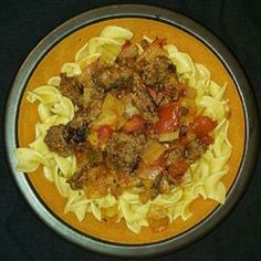 a plate full of pasta with meat and vegetables