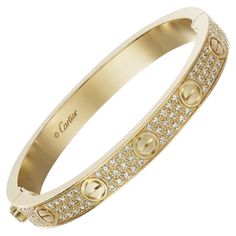 CARTIER LOVE BRACELET Cartier 'Love' bangle bracelet crafted in 18k yellow gold with gold screw tops and pave set round brilliant cut diamonds (D-F in color, VVS clarity) Signed Cartier, 750, with serial number and hallmarks The bracelet is presented with a Cartier box and certificate upon sale In 18k yellow gold and pavé of diamonds total 204 diamonds total 2 ct and weight gold 33 gr In size 16 Original at shop at 48.300€ If the robust locking mechanism and miniature screw heads that characteri Luxury Cartier Gold Bracelet For Wedding, Cartier Love Bracelet Diamond Pave, Luxury Cartier Gold Bracelet With 17 Jewels, Cartier Luxury Gold Bracelet For Formal Occasions, Gold Bracelet Cartier, Love Bracelet Cartier, Cartier Love Bangle, Bracelet Cartier