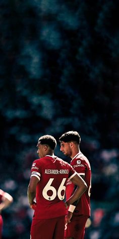 two soccer players standing next to each other