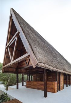 a wooden building with a thatched roof