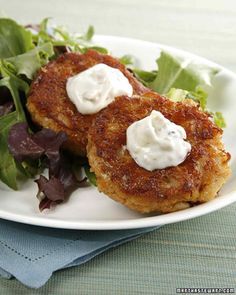 two crab cakes on a white plate with lettuce