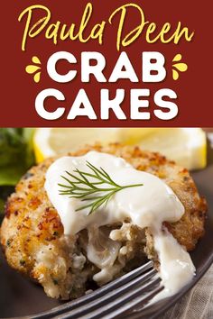 crab cakes on a black plate with a fork and lemon wedges in the background