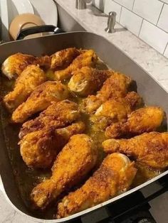 fried chicken is cooking in a pan on the stove