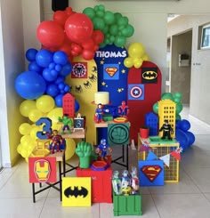 a room filled with balloons, toys and other items on the floor in front of a wall