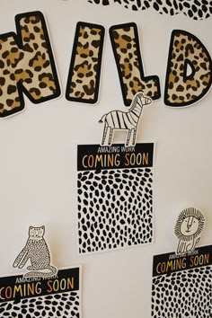 some animal themed magnets are hanging on the wall in front of a sign that says wild