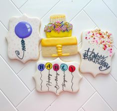 four decorated cookies with happy birthday written on them