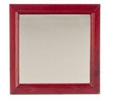 a red framed mirror on a white wall with a reflection in the bottom right corner