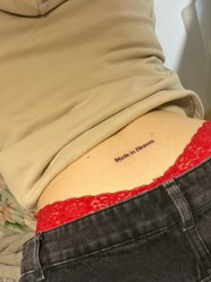 a woman's lower back tattoo with the word made in heaven written on it