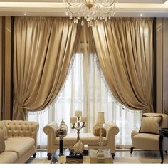 a living room with couches, chairs and chandelier