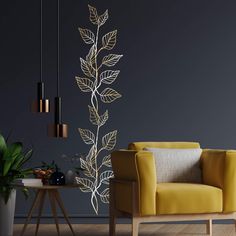 a yellow chair sitting in front of a black wall with gold leaf designs on it