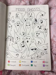 an open book with drawings in it on a pink bed sheet and the words mood ghosts