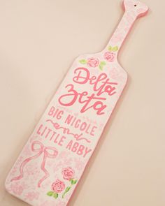 a pink bottle shaped sign that says do not give big nicole and little aby