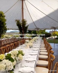 an outdoor tent with tables and chairs set up for a formal dinner or party event