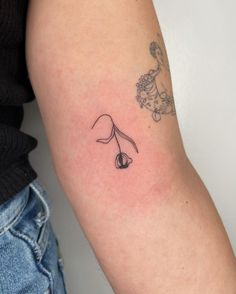 a woman's arm with a tattoo on the left side of her right arm