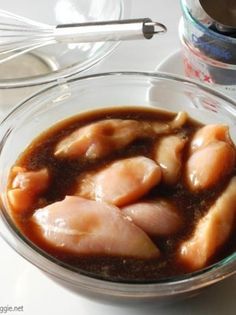 a glass bowl filled with food on top of a table