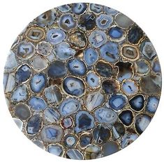 a round glass plate with blue agate and gold foiled designs on the surface