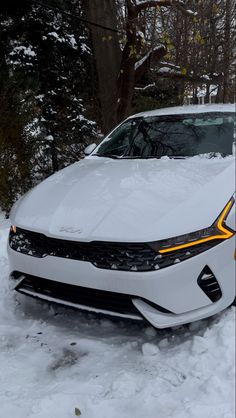 a white car is parked in the snow