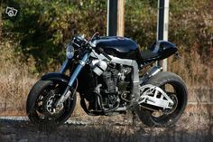 a black and silver motorcycle parked on the side of the road