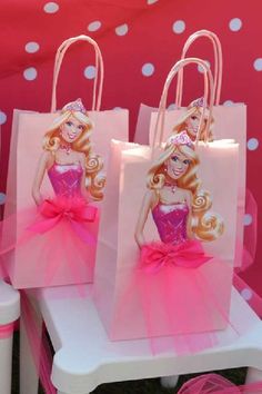 some pink bags with barbie dolls on them