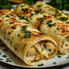 two burritos on a plate with parsley