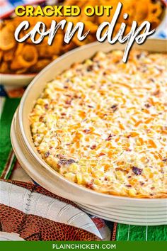 baked corn dip in a casserole dish with crackers and chips on the side