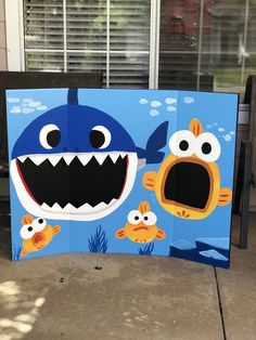 a cardboard cut out of a shark and two fish