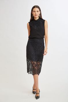 Reach for our Crochet Lace Midi Skirt for a sophisticated, fresh Fall look. The beautiful, scalloped hem is accented by the shorter lining for a glimpse of leg. Dress it down with a vegan leather jacket or cashmere or up with Satin. Limited Edition 50th Anniversary Collection Elie Tahari Exclusive Crochet Lace Midi Skirt 100% Polyester Runs true to Size Length From Waist to Hem: Back 30.25"L (approx. length for size 6) Model is 5'9" and wearing size 2 Dry Clean Only Imported Style #: E905R304 Black Lace Midi Skirt Outfit, Lace Midi Skirt Outfit, Midi Outfits, Black Lace Skirt, Tahari Dress, Lace Midi Skirt, Midi Skirt Outfit, Vegan Leather Jacket, Elie Tahari