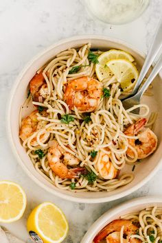 two bowls of shrimp pasta with lemon and parsley