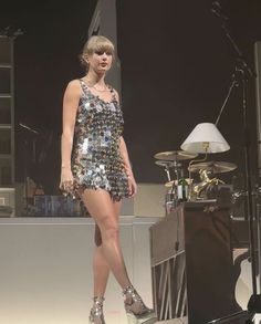 a woman in a short dress standing on stage