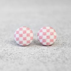 Pink and white checkerboard pattern fabric button earrings. Rachel O's is proud to offer the ultimate in fabric covered button jewelry. Earring measures approx .5 inch wide, and has a hypoallergenic, titanium post. Posts are nickel-free and cadmium free. Fabric buttons are made of 100% cotton, hand stretched (by me) over an aluminum dome. Photos of solid white buttons are included for size reference ONLY. Ruler and ear are NOT included. You will receive one pair of earrings as seen in the first Fabric Button Earrings, Red Earrings Stud, Fabric Buttons, Fabric Earrings, Gingham Fabric, Check Fabric, Checkerboard Pattern, Jewelry Earring, Button Jewelry