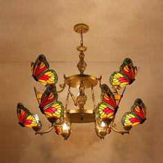 a chandelier with many butterflies hanging from it