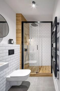 a bathroom with a stand up shower next to a white toilet