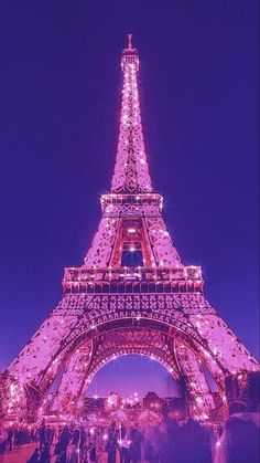 the eiffel tower lit up at night