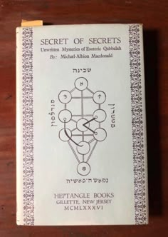 the secret of secrets book on a wooden table