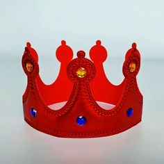 a red crown with blue jewels on it