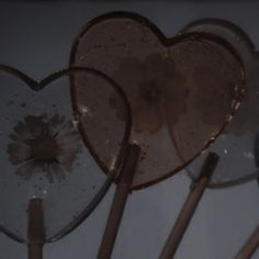 several heart shaped lollipop sticks are arranged in a row