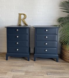 two blue dressers side by side with the letter r on top