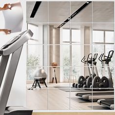 there is a mirror that shows the inside of a gym with treads and exercise equipment