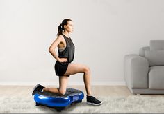 a woman is standing on an exercise steppe