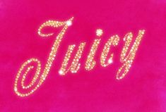 the word juicy written in gold glitter on a pink background